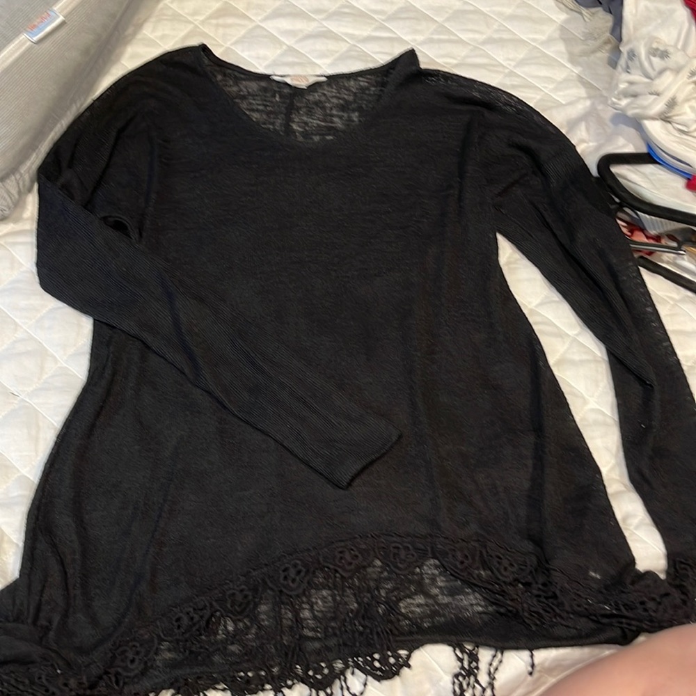 Black long sleeve fringe bottom sweater.